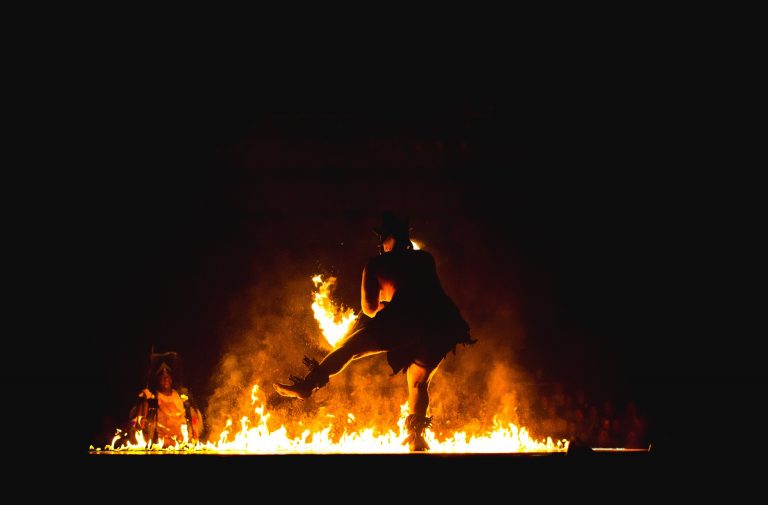 Man dancing in a bonfire ritual