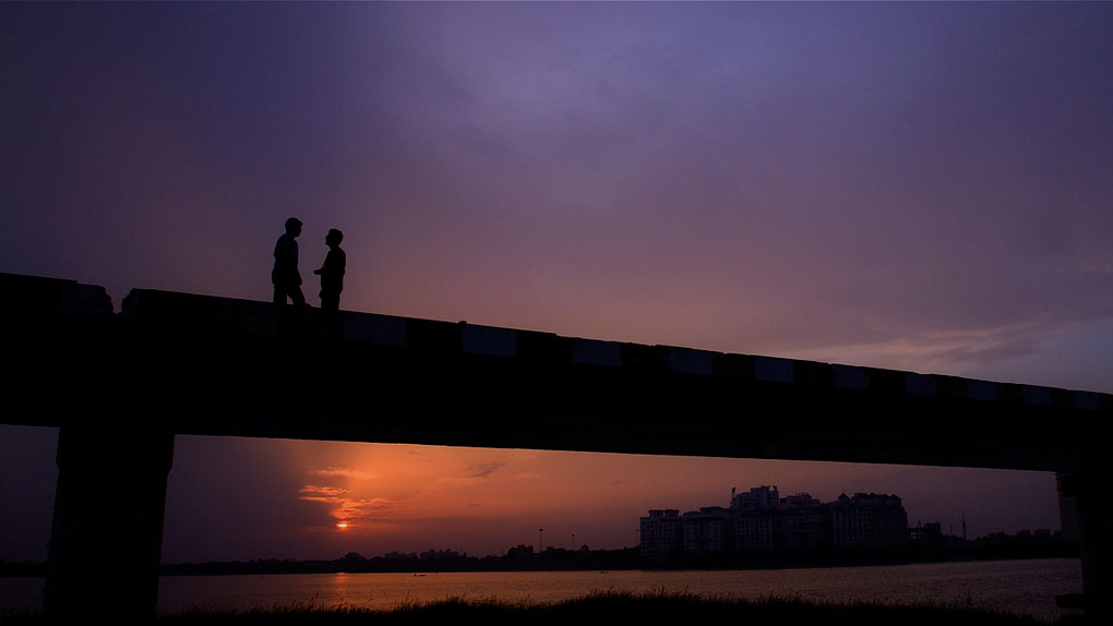 Friends on a Bridge at Twilight, Chennai, India