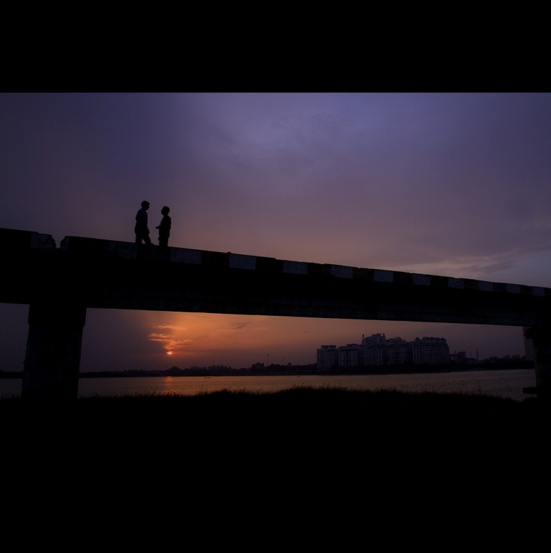 Friends on a Bridge at Twilight, India