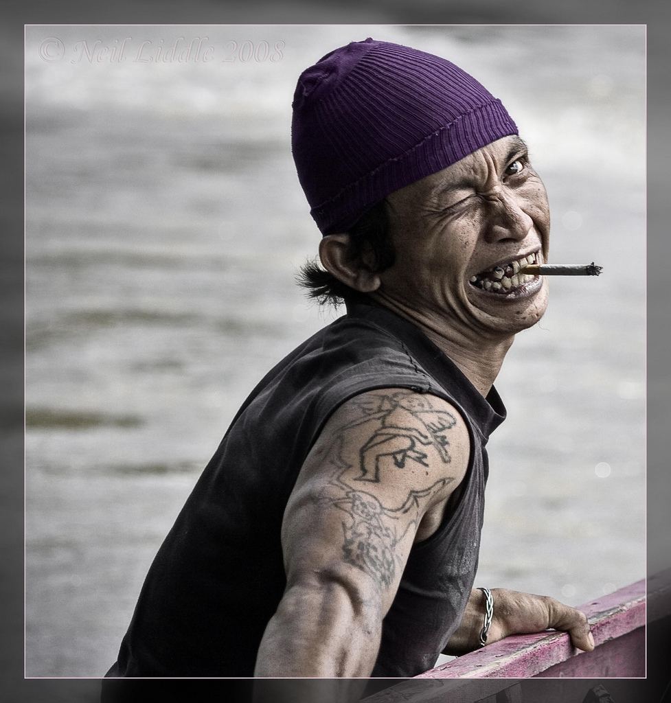 Man in boat on Kayan River (Indonesia) with exaggerated "pirate" expression