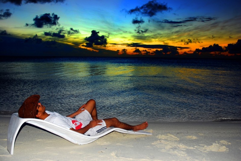 Man relaxing on a beach chair in Maldives