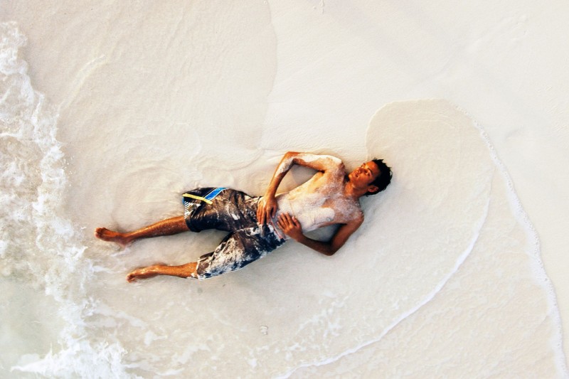 Man relaxing on beach in Maldives