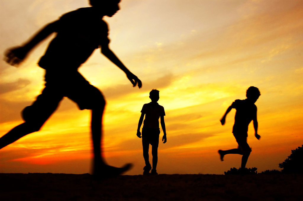 Silhouette of children playing in Maldives