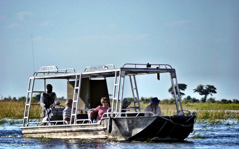Small skiff explores the Chobe River in Botswana, Africa