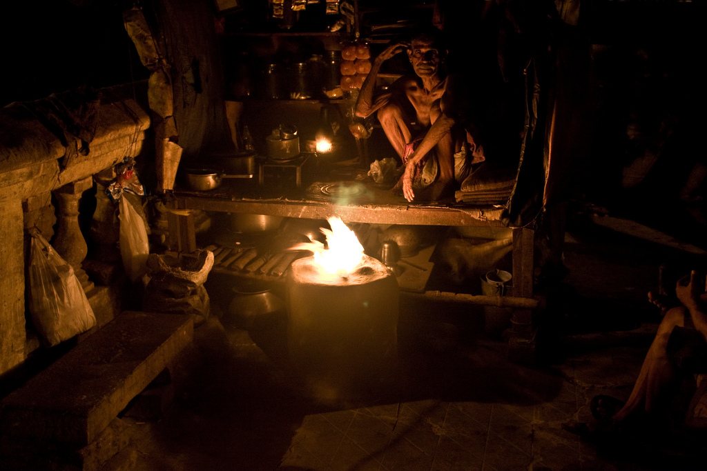 Tea Man Sitting Near Fire, India