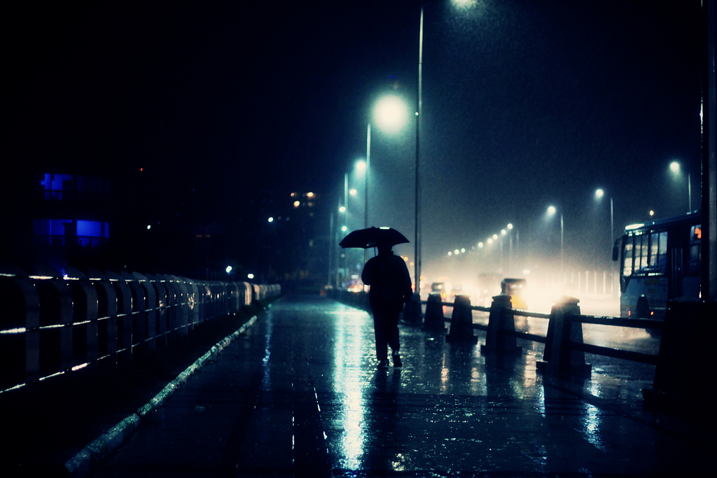 Man walking in rain in India