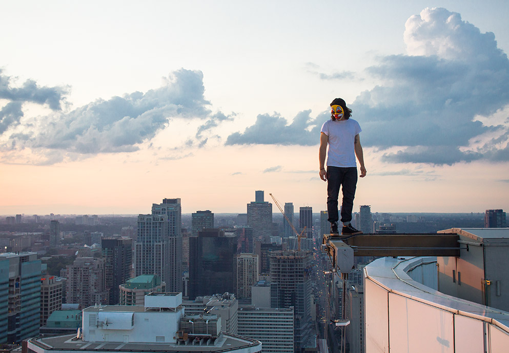 Man standing on an i-beam over edge of skyscraper