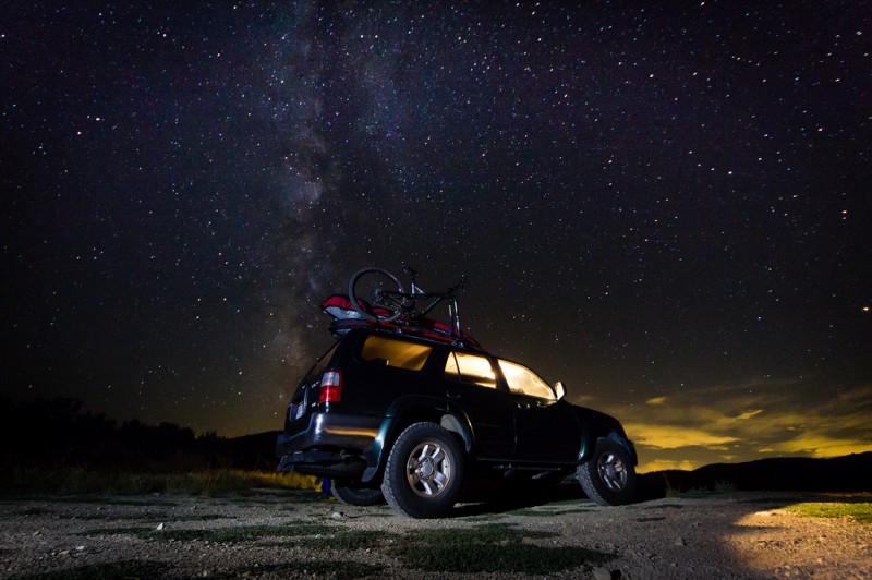 Truck parked at night with bright stars, Wyoming