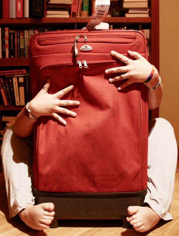 Woman Embracing Red Suitcase